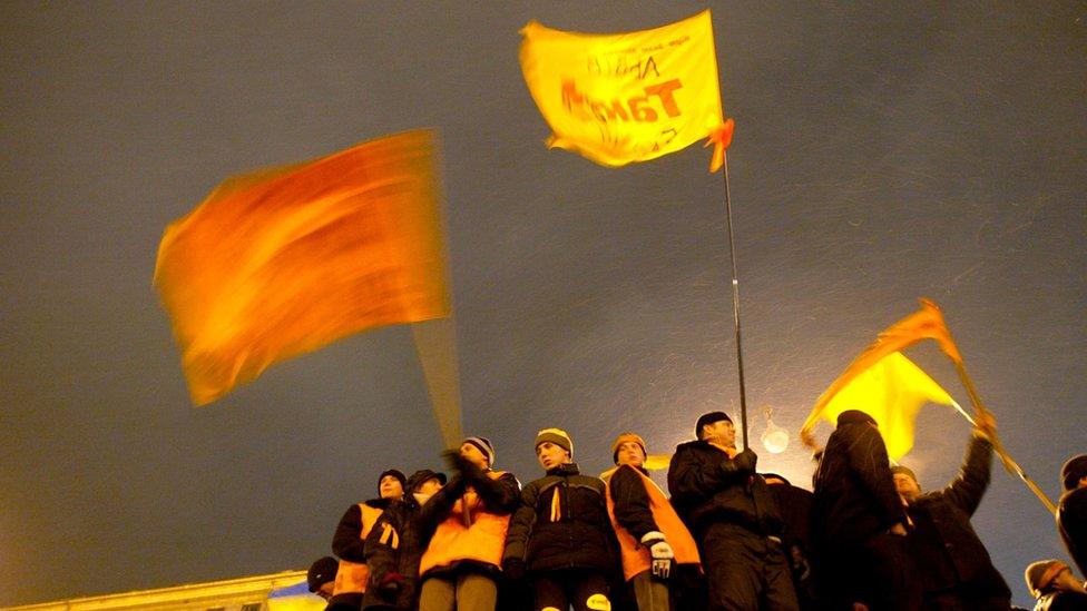 Supporters of Viktor Yushchenko wave flags during a November 2004 rally in Kiev