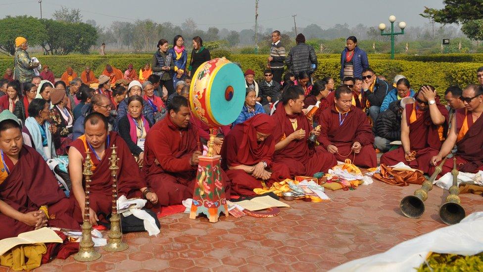 Buddhist monks perform puja in front of the Mayadevi temple in Lumbini