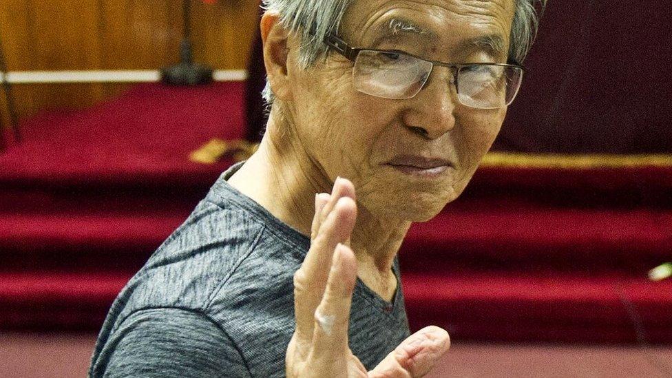 Peru's ex-President Alberto Fujimori gestures before the reading of the verdict on charges of embezzling state funds and using them to manipulate the media, at a police base in Lima, 8 January 2015