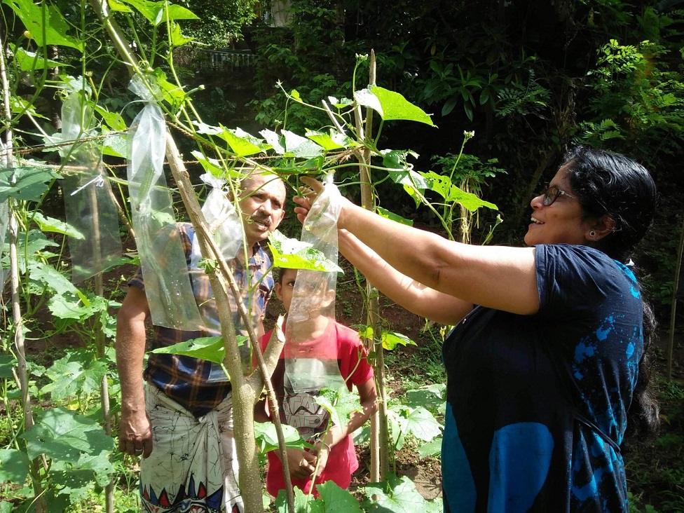 Anoma and family in her vegetable patch