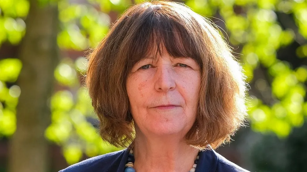 Denise Gaines, West Berkshire Council deputy leader, with shoulder length brown hair. Outside on a sunny day with green trees in the background 