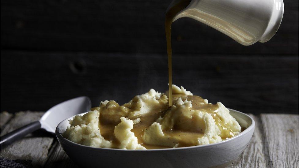 Gravy poured onto mash potatoes