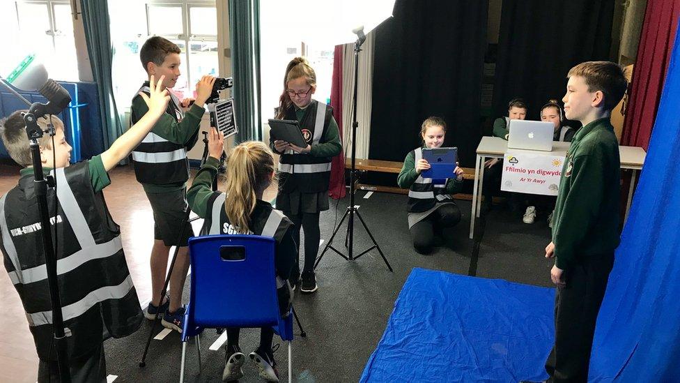 Children producing a weather bulletin