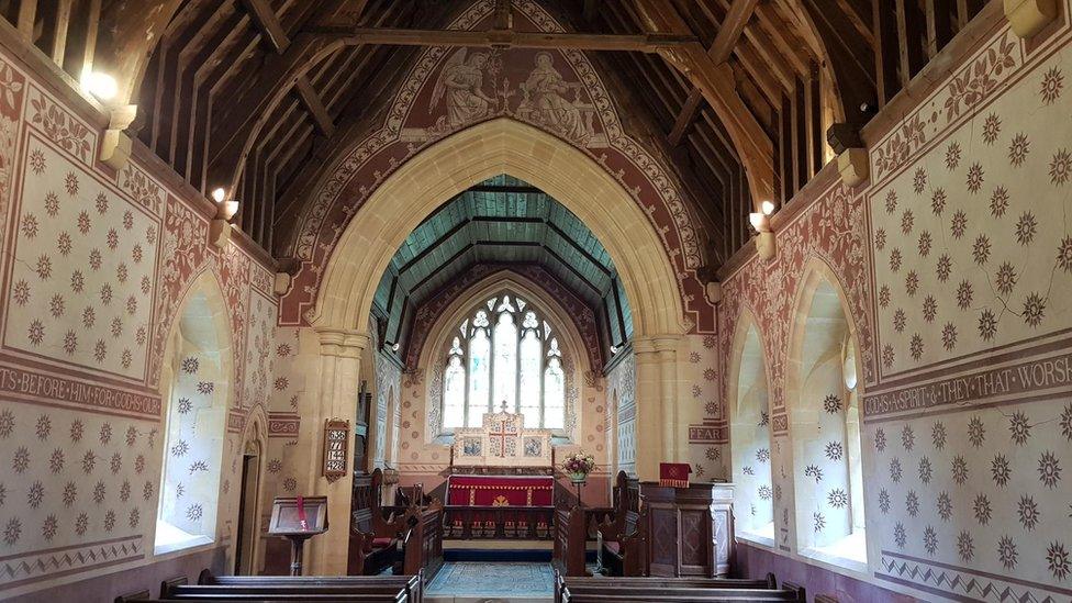 The interior of an historic church looking towards the nave