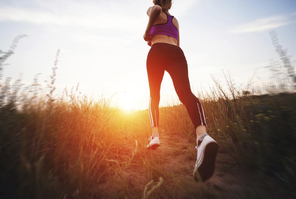 Woman running at sunset