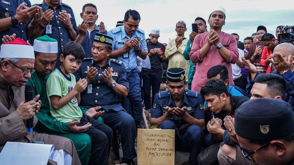 Malaysian Muslims offer prayers for a victim of the Darul Quran Ittifaqiyah religious school fire during a burial ceremony at Raudhatul Sakinah cemetery in Kuala Lumpur on September 15, 2017.