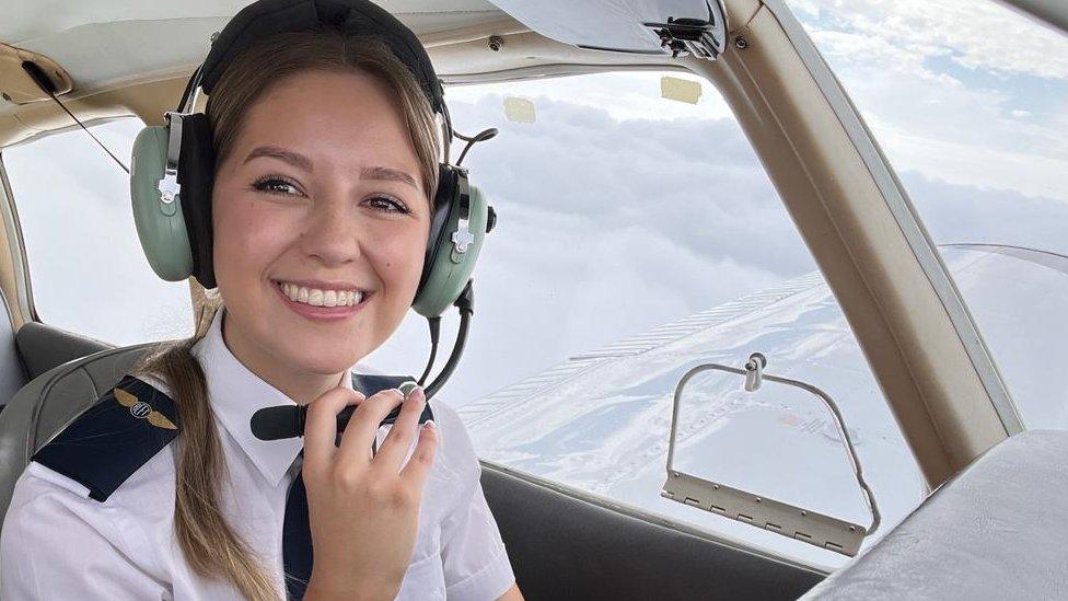 Lily Ayres flying a plane