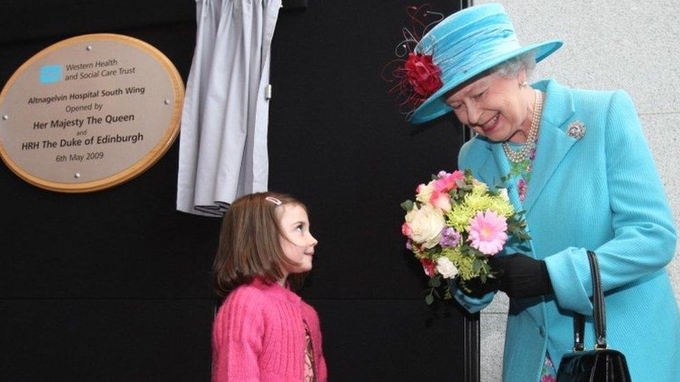 The Queen receives flowers from Eimear Doherty, five, at Altnagelvin Hospital, Londonderry in May 2009