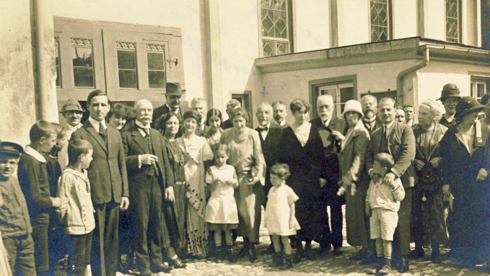 Tea party at the Steinmeyer garden, June 1924: Khurshedben is the first from the right amongst those seated at the table. Photo taken at the Steinmeyer musical organ factory in Oettingen, Germany. Khurshedben had travelled with Eva Palmer Sikelianos to Oettingen for the purchase of an organ.