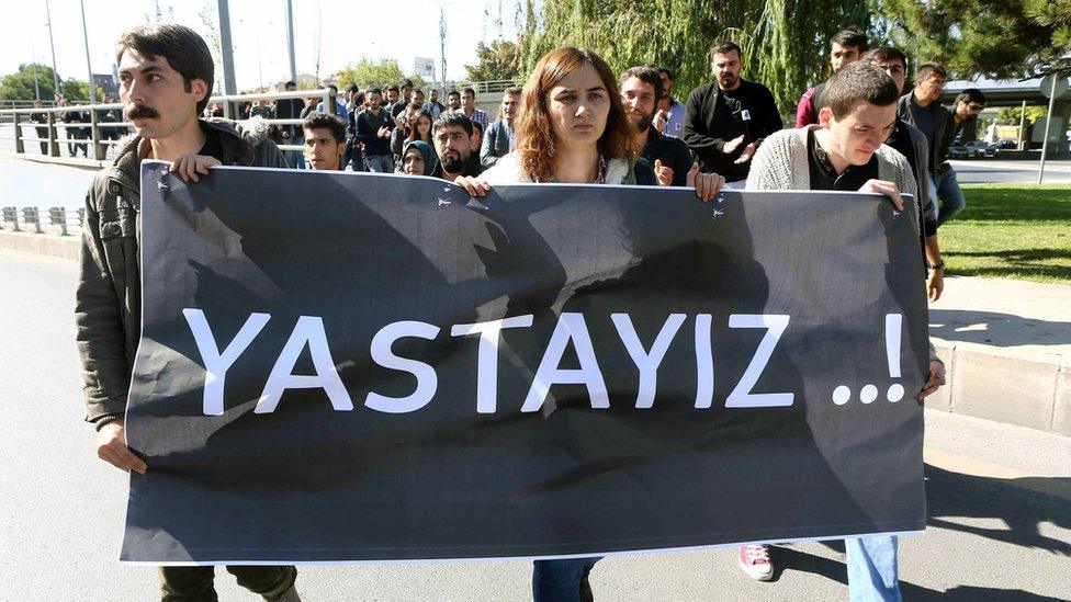 A group of students from Ankara University, holding a banner reading 'We are mourning', march on October 14, 2015 in Ankara, to protest against the deadly attacks in Ankara