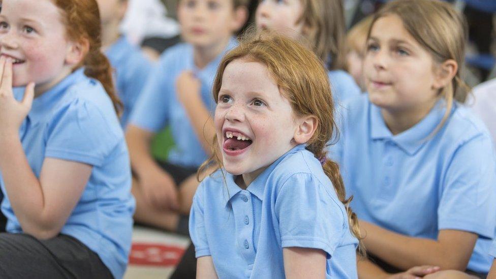 Stock image of young pupils paying attention in class