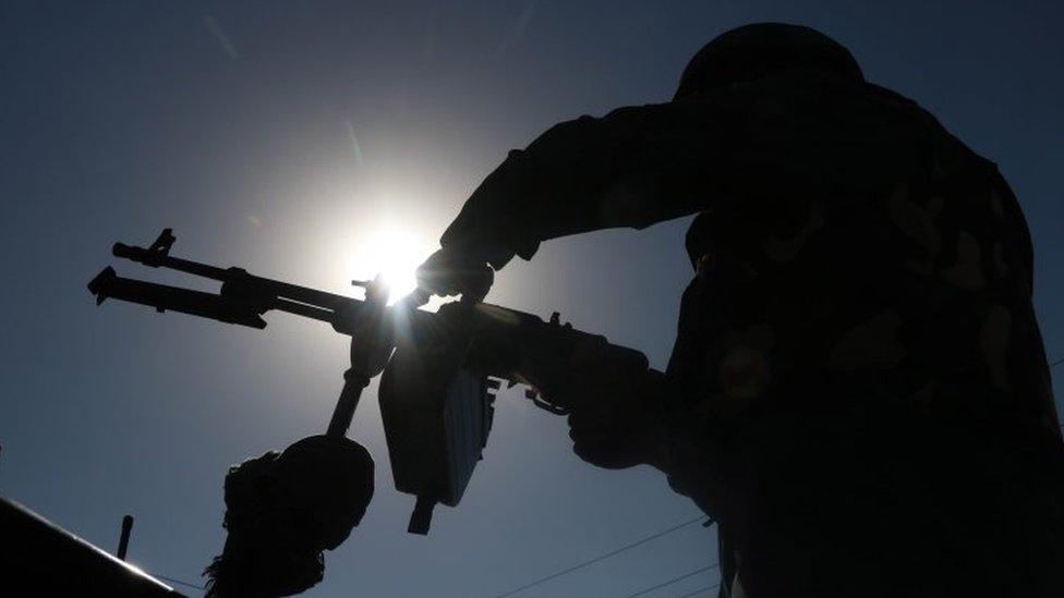 An afghan security official stands guard during a ceremony in which people belonging to different political parties distributed gifts and souvenirs to Afghan forces to encourage their fighting for the country, in Herat, Afghanistan, 05 July 2021.