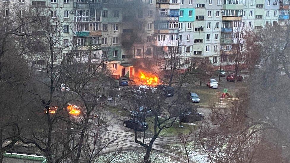 A fire is seen in Mariupol after Russia launched a massive military operation against Ukraine