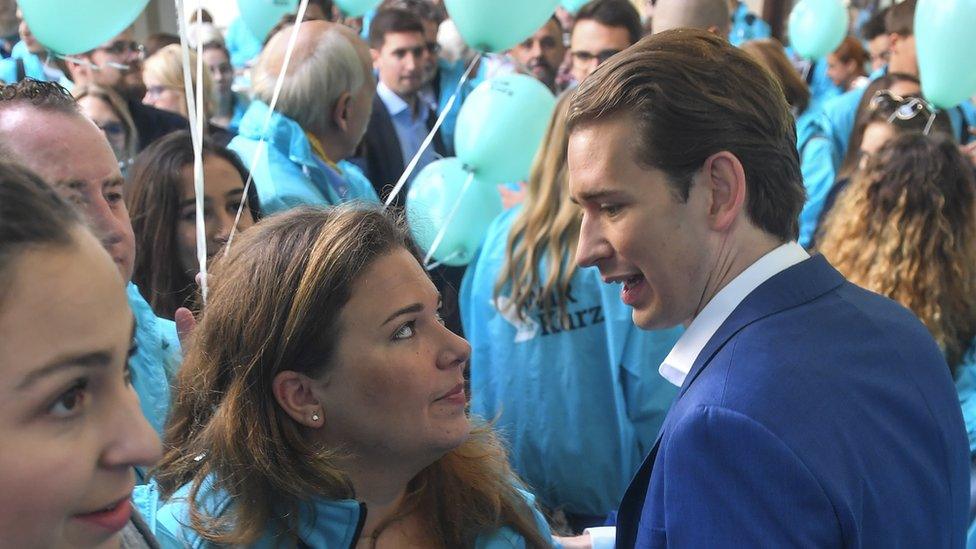 Sebastian Kurz talks to a party supporter in Vienna on 27 September