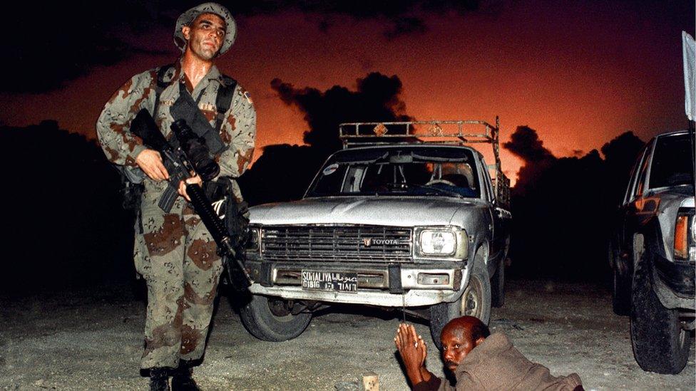 A US Marine orders Somalian man to the ground in Mogadishu, 1992