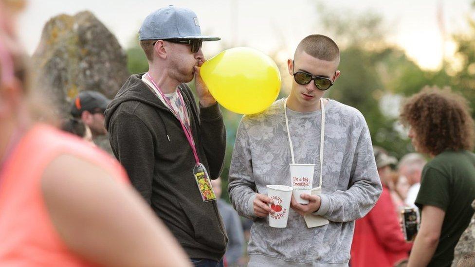 Festivalgoer inhales nitrous oxide