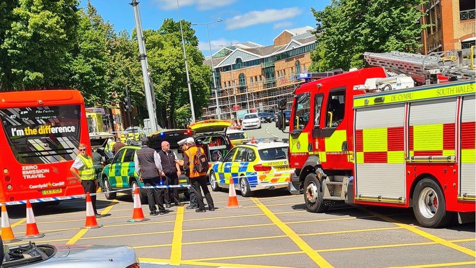 Police cars and fire engine at the scene