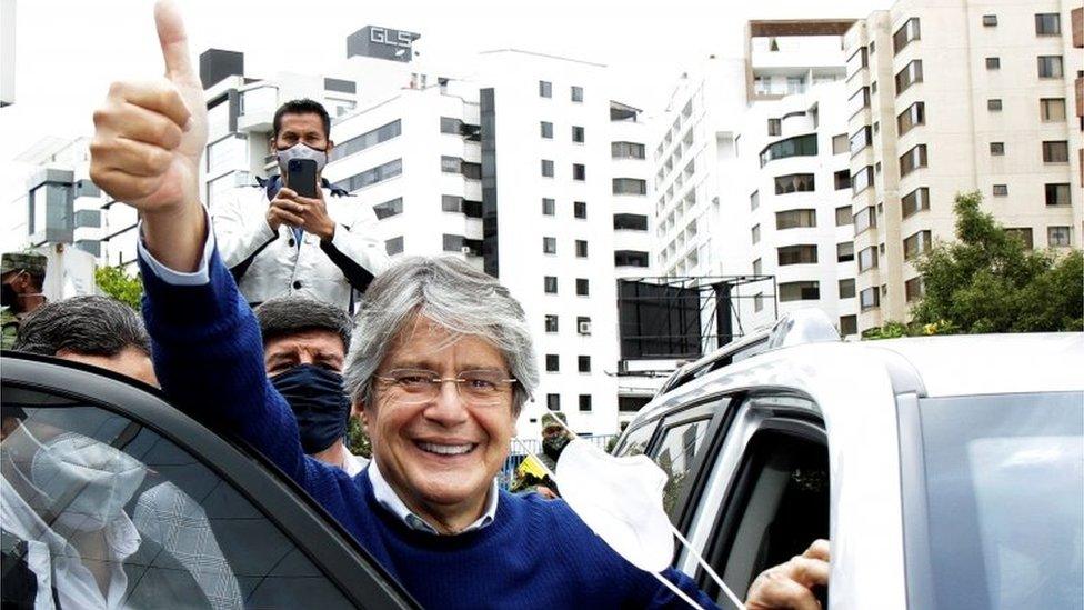 Guillermo Lasso waves to supporters as he leaves the Electoral National Council (CNE) in Quito, Ecuador, February 12, 2021.