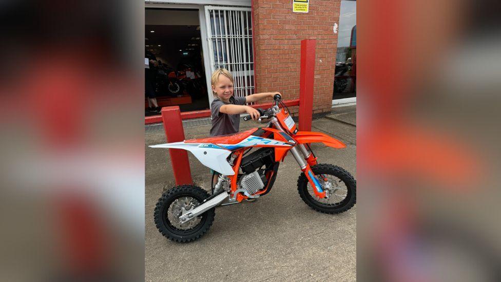 Cooper's new orange and white motocross bike