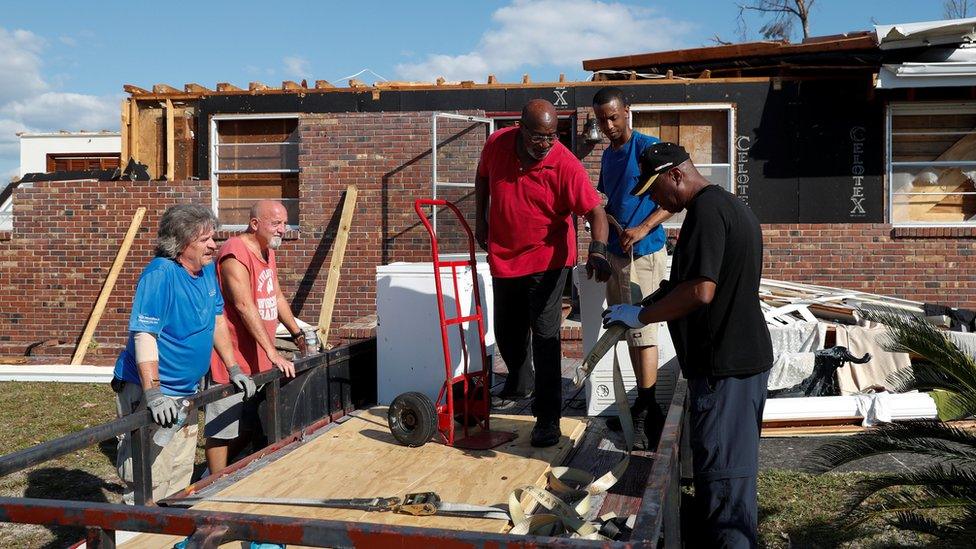 Dexter Humphries moves furniture out of his home in the aftermath of Hurricane Michael in Springfield, Florida, US, October 14, 2018.