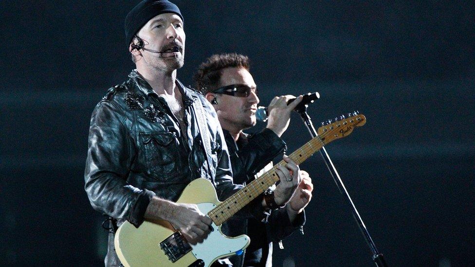 U2's The Edge and Bono performing on stage