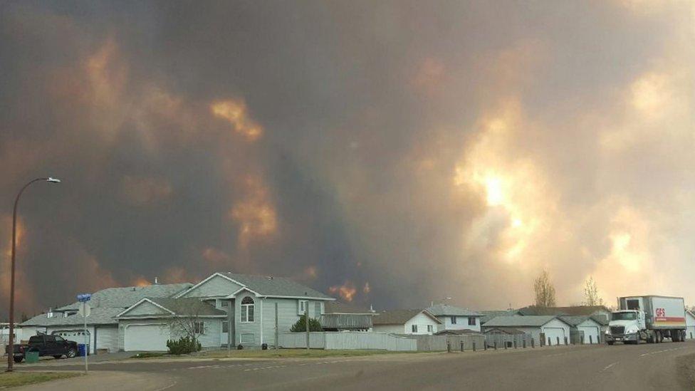 Smoke rises from a wildfire outside of Fort McMurray, Alberta,