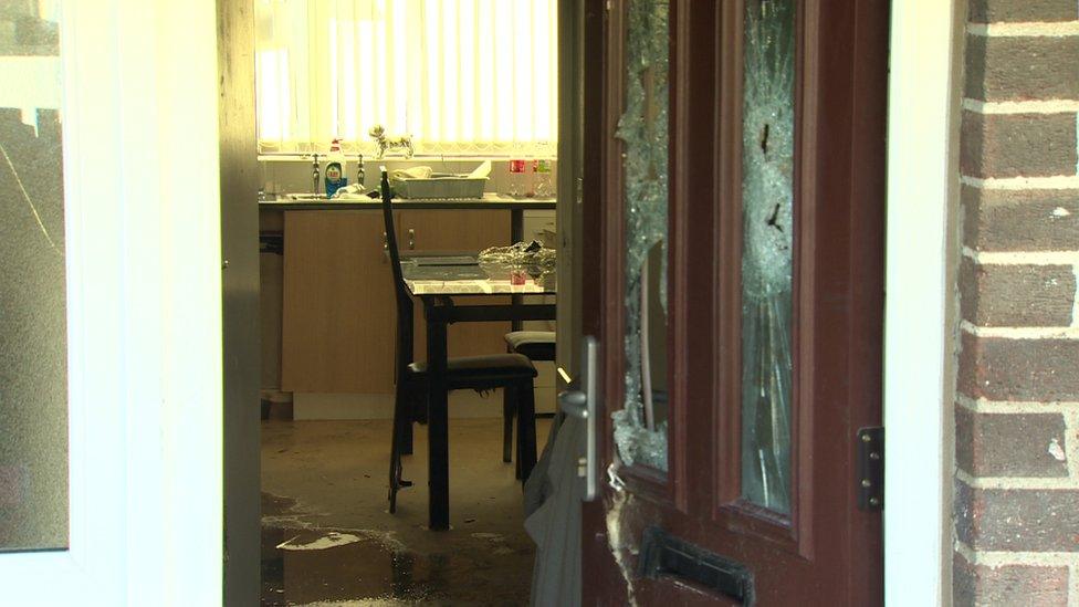 The hallway and kitchen of the fire-damaged house