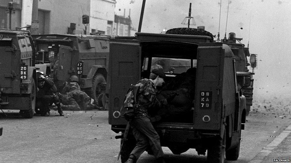 Soldiers taking cover under fire