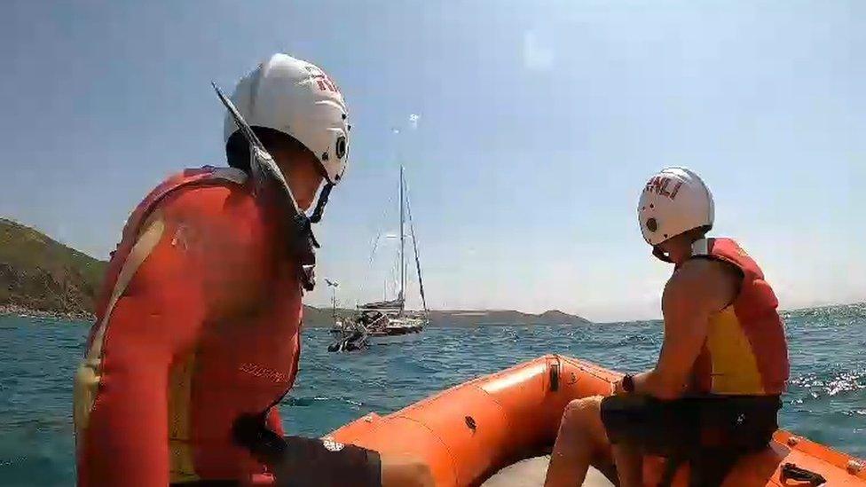 RNLI lifeguards during rescues along Whitsand Bay