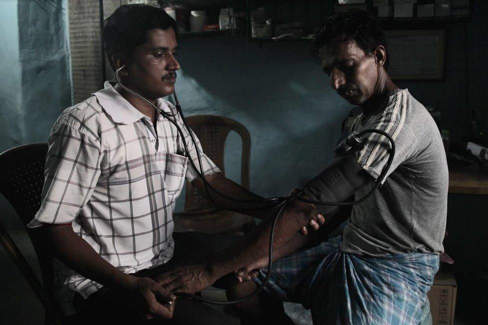 Sanjoy Mondal checking blood pressure level of a patient