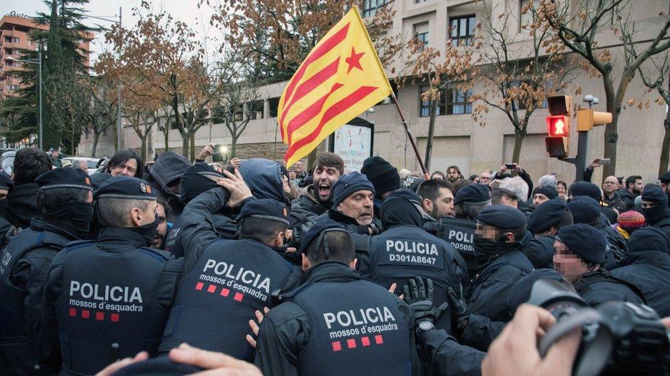 Spanish demonstrators scuffle with members of the Catalonian regional Police (Mossos d"Esquadra) outside of the Lleida Museum, in Lleida, Catalonia