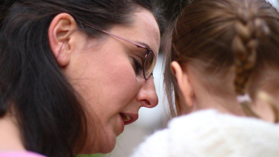 Woman talks to girl