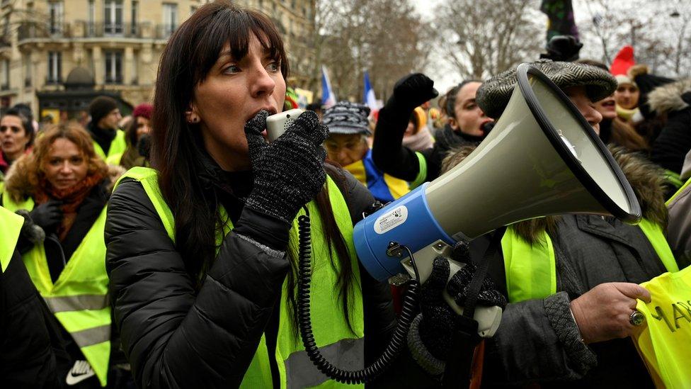 French women yellow vest protesters walk near the Eiffel Tower on 20 Jan