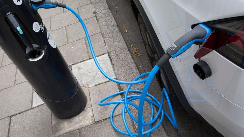 Electric car charging at charging point