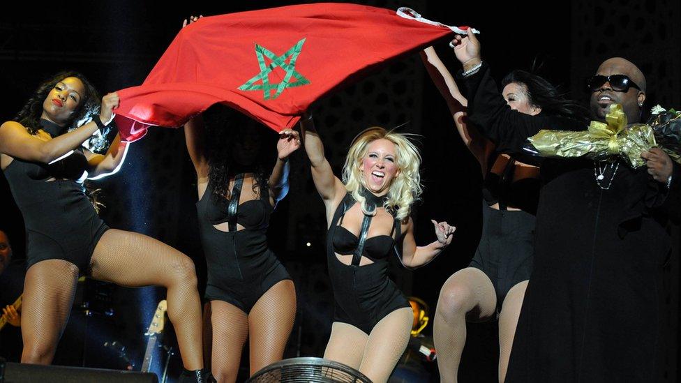 US singer Ceelo Green and dancers hold up the Moroccan flag during Mawazine festival in 2013.