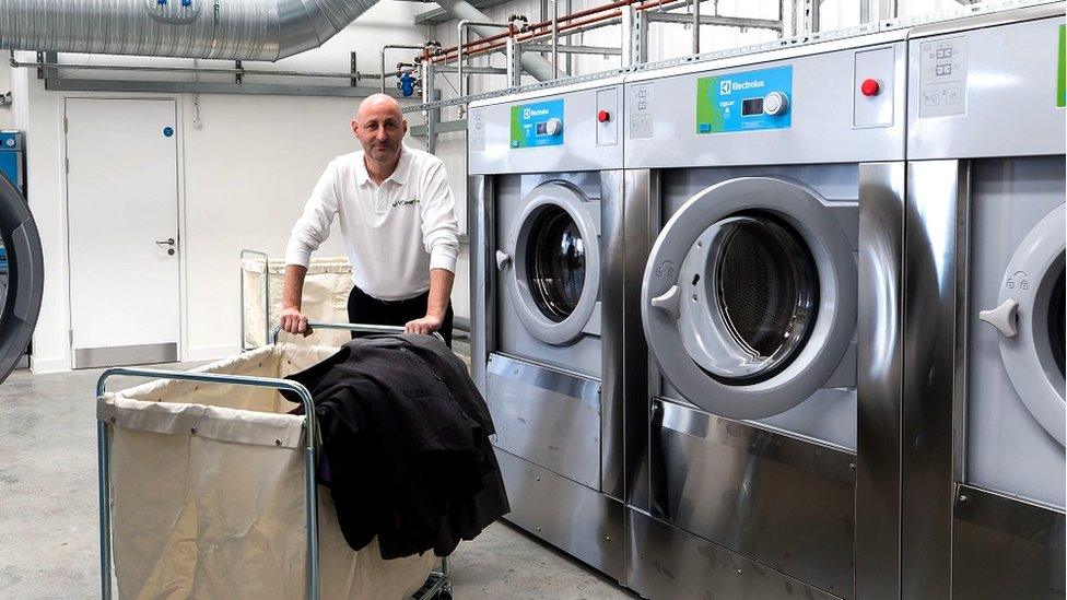 Nick Harris in front of dry cleaning machines