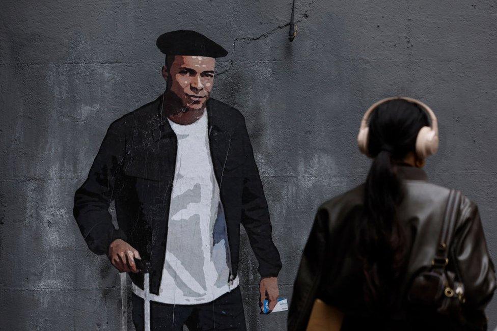 This photograph taken on 30 April shows a mural called The Mbappe Law by Italian urban artist Salvatore Benintende aka "TV BOY".