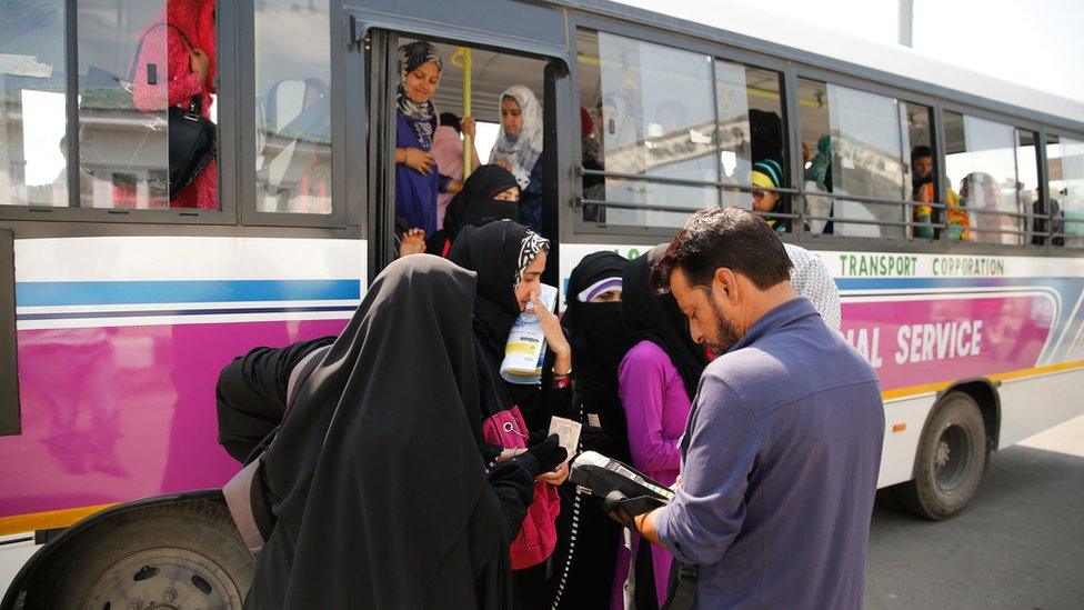 Women passengers buy tickets