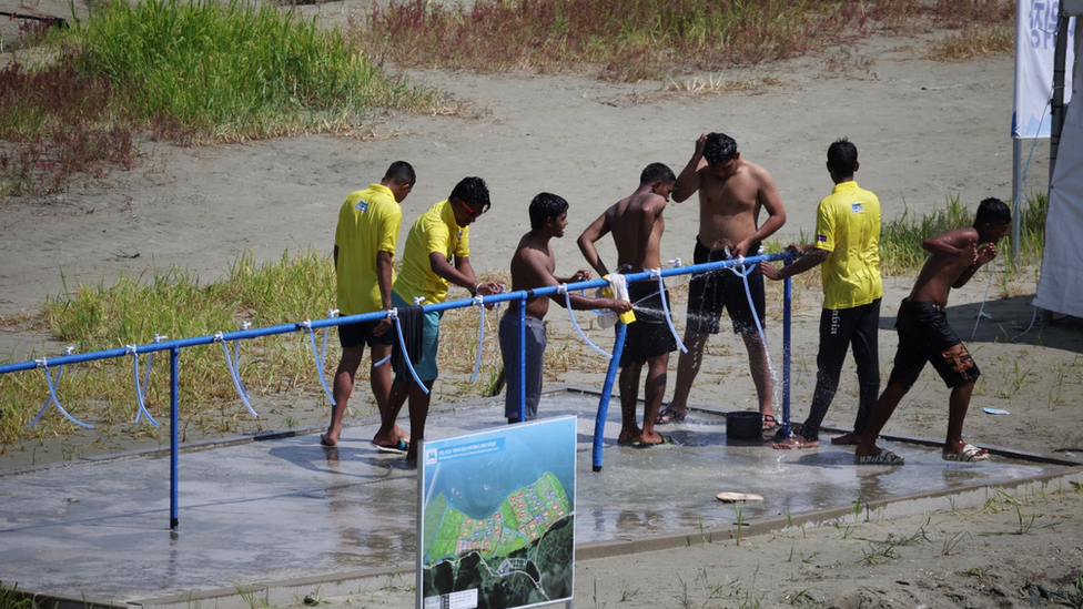 Participants hosing themselves off to stay cool at the site as a heatwave grips South Korea