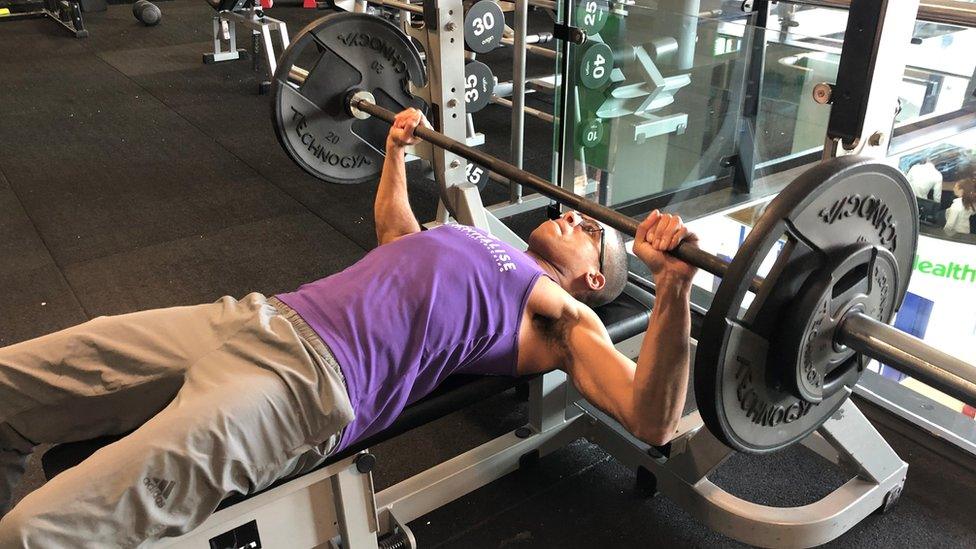 Lee Chambers using a weight machine at the gym