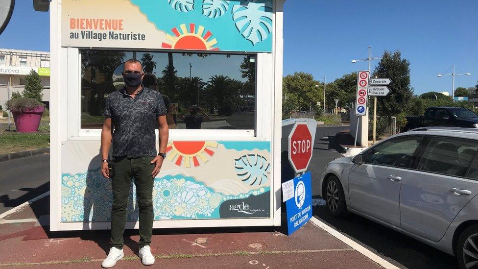 David Masella at the entrance to the naturist village