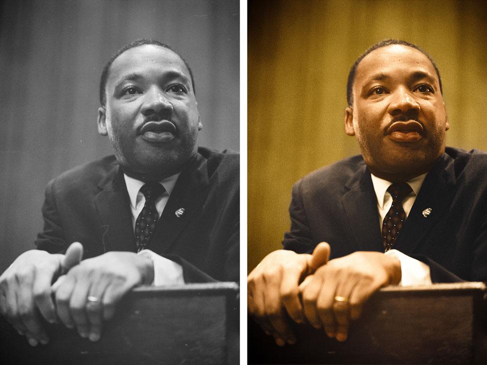 Dr. Martin Luther King leans forward over a podium