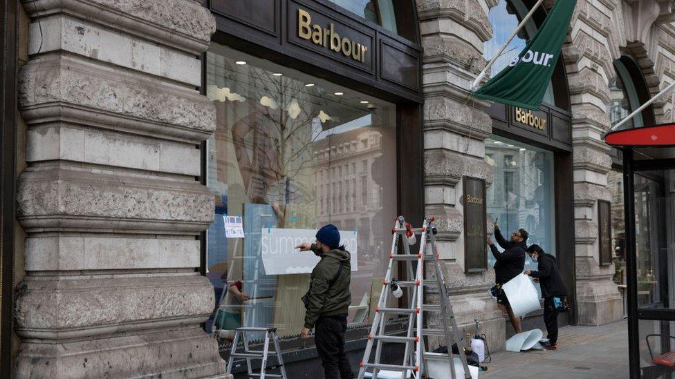 New window displays being created by staff at a store on Regent Street in London in preparation for reopening on 12 April