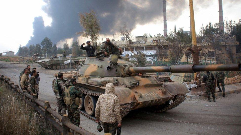 Syrian government forces patrol near Aleppo's power plant after taking control of the area on the eastern outskirts of the city from Islamic State (IS) group on 21 February 2016