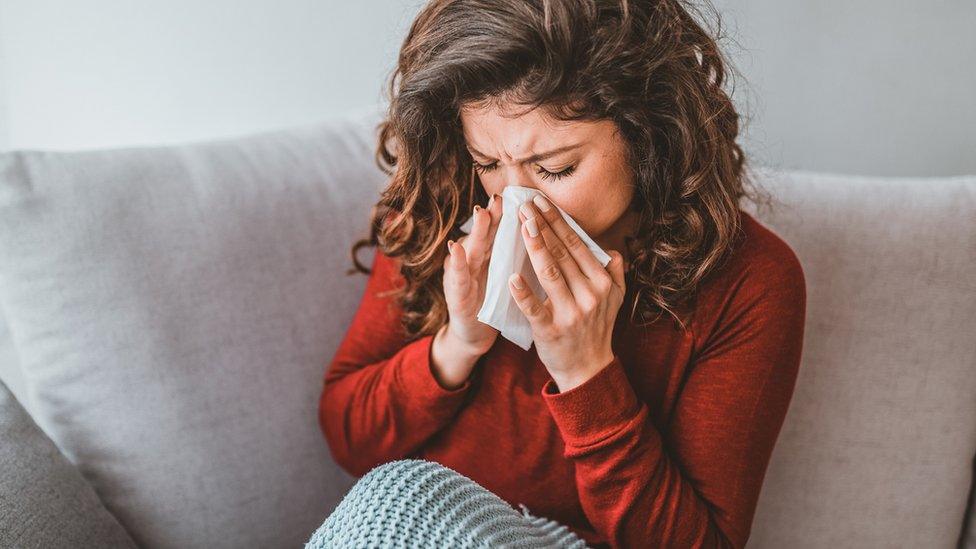 Woman sneezing