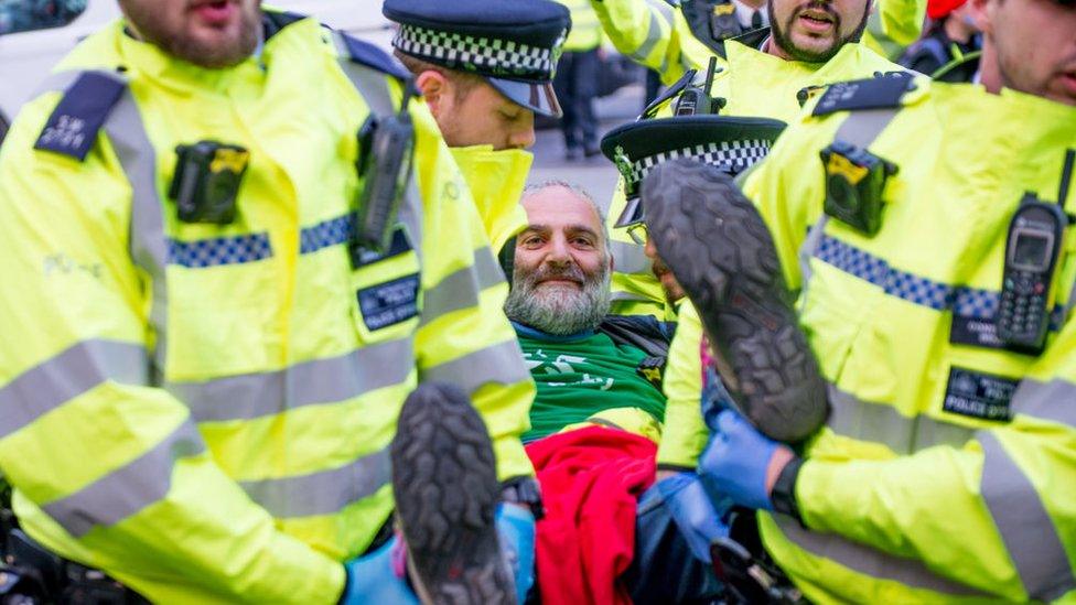 Protester being carried away by police