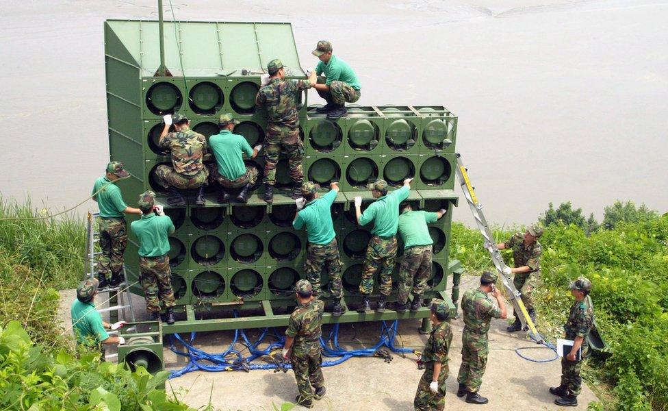 Army engineers assemble a huge speaker stack near the DMZ.