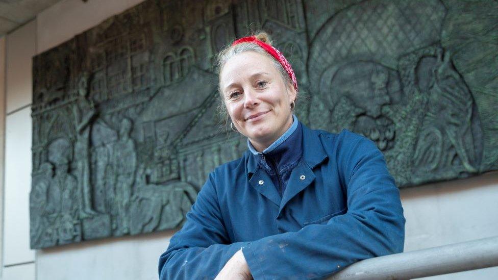 Louise Gridley in front of one of the murals