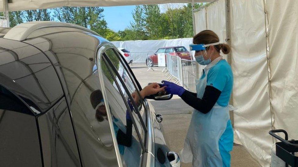 Person having finger prick test through car window