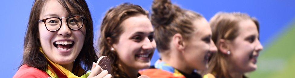 Fu Yuanhui grinning broadly on the podium after winning the backstroke 100m